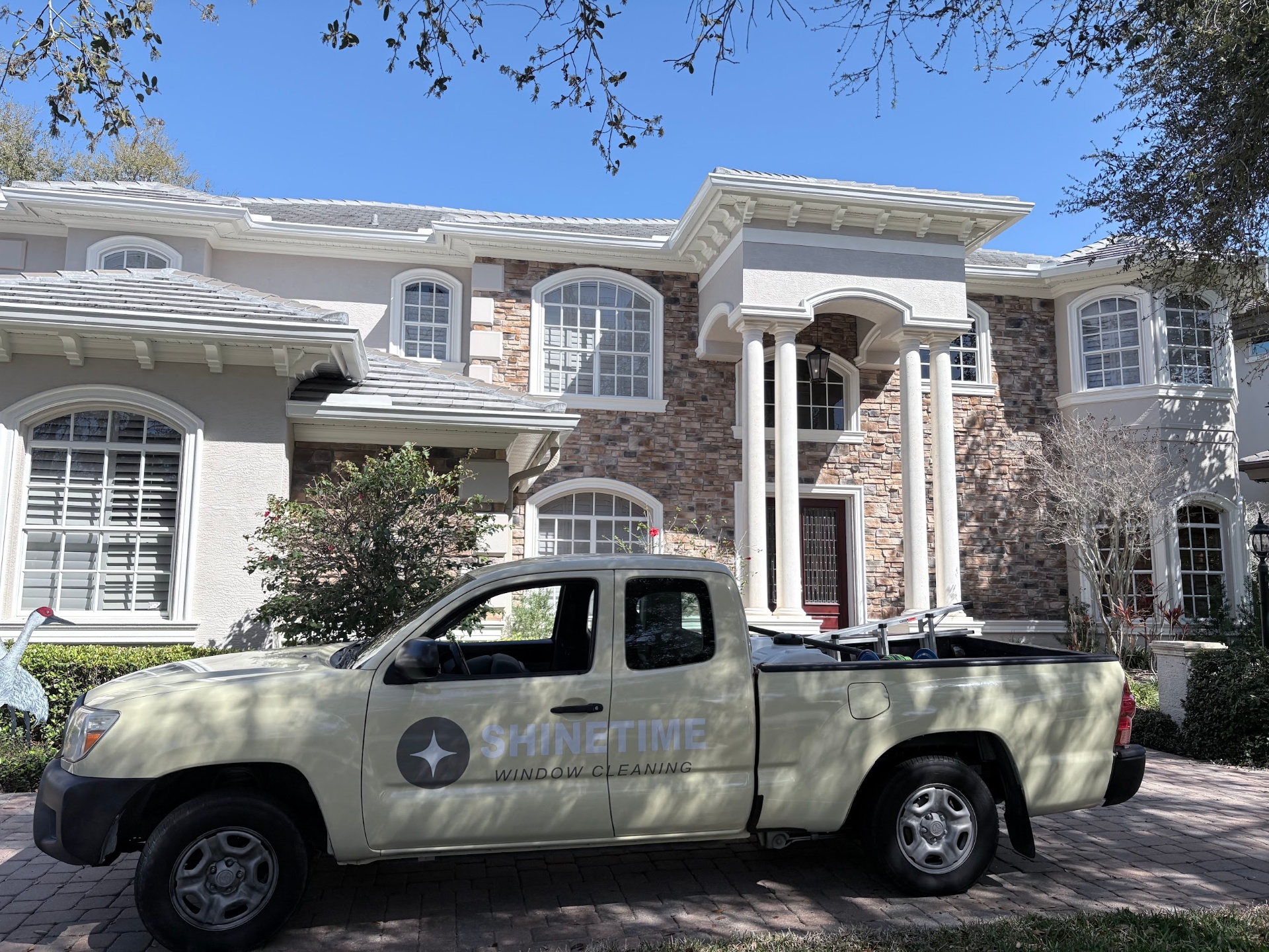 Shine Time truck servicing a stone-front Tampa Bay home